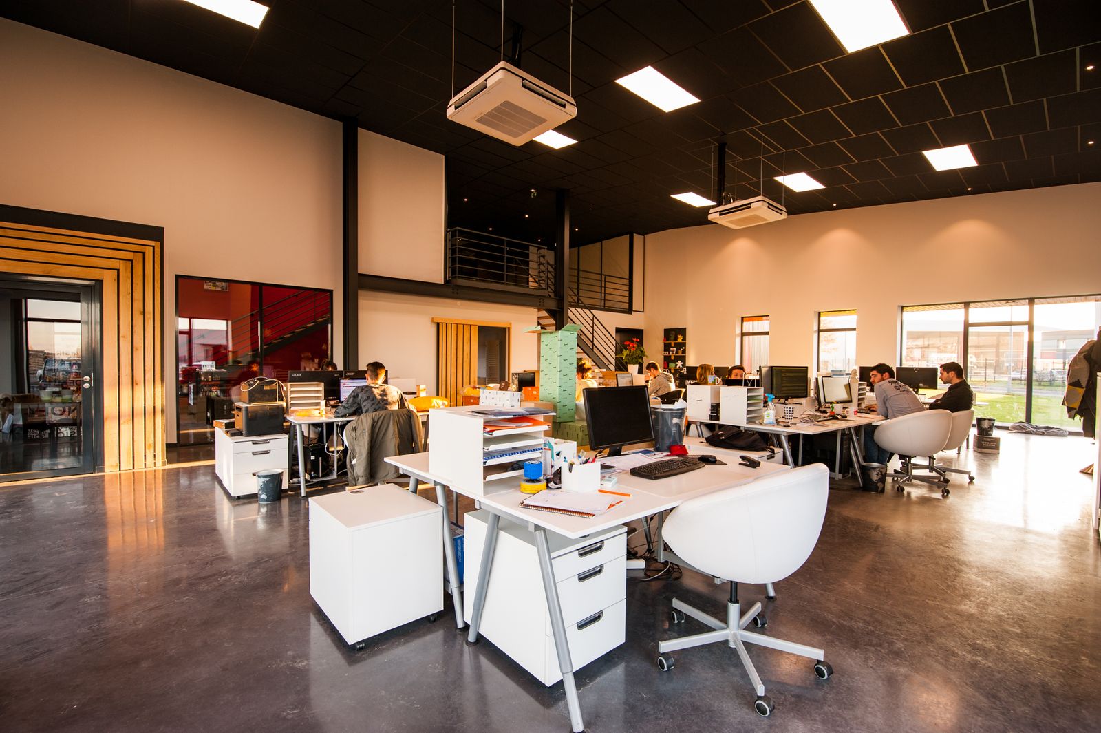 Modern open-plan workspace with desks and meeting areas